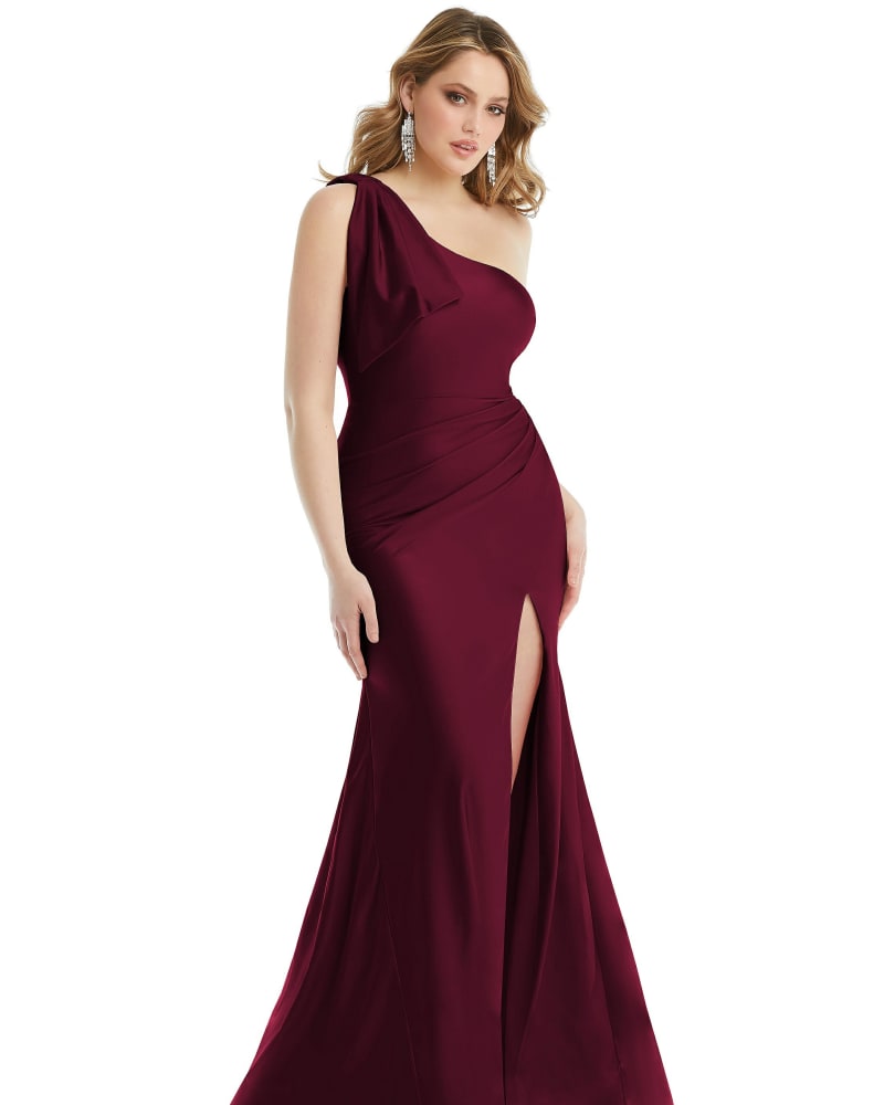 Front of a model wearing a size XL Cascading Bow One-Shoulder Stretch Satin Mermaid Dress with Slight Train in Cabernet by Cynthia & Sahar. | dia_product_style_image_id:301303